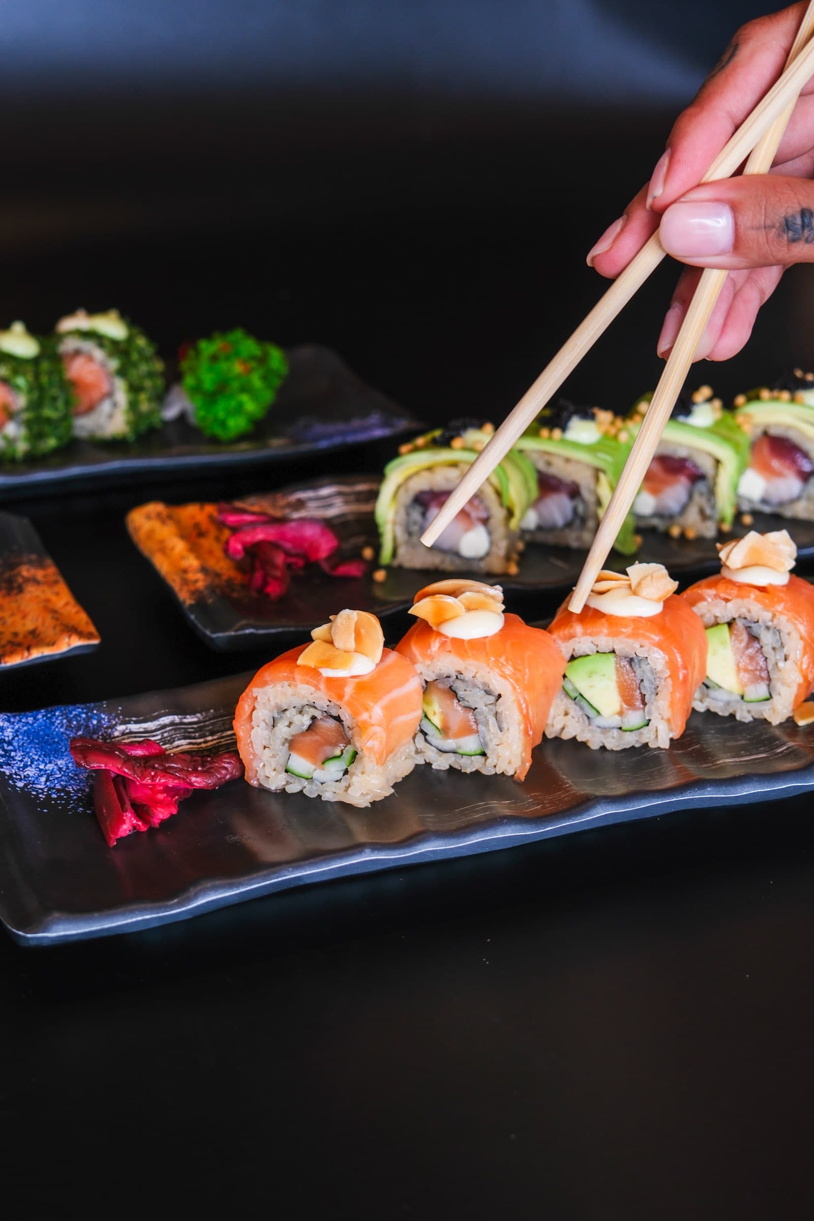 Fresh salmon rolls topped with almond flakes