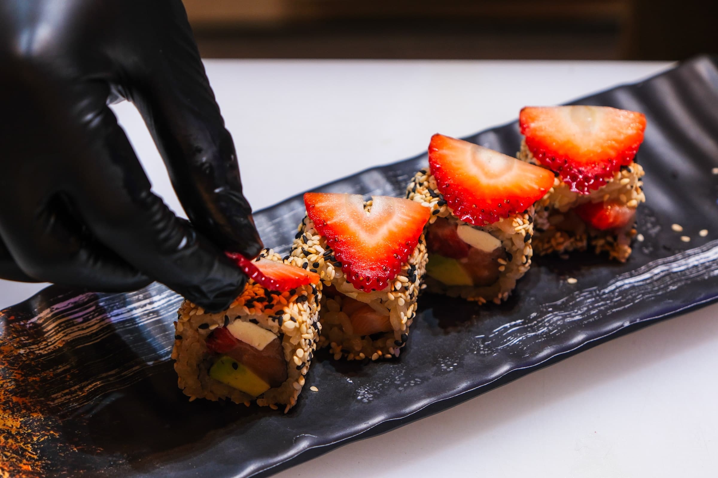 Sesame roll topped with fresh strawberry